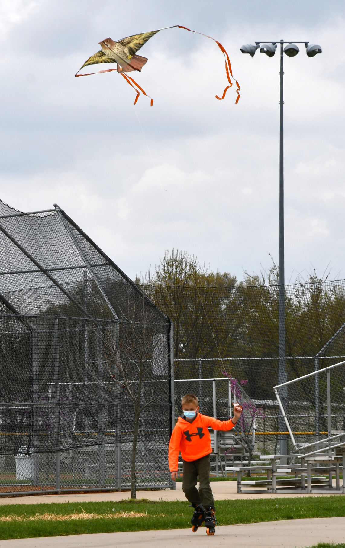 Sam Brueggemenn holds a kite while skating